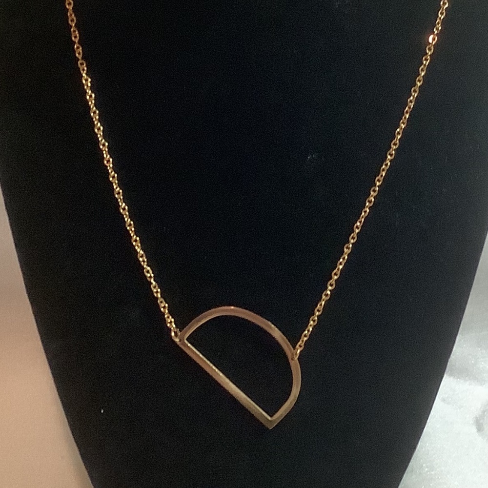Gold toned D necklace
